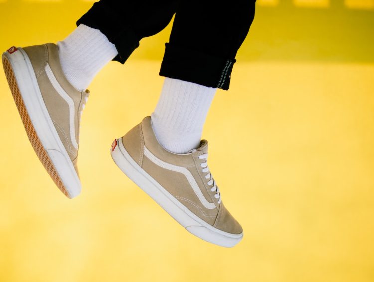 person wearing black and white nike sneakers